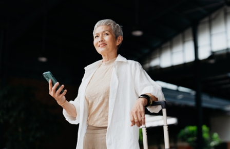 Mature woman holding a mobile at the airport