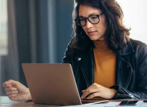 Businesswoman booking travel on laptop