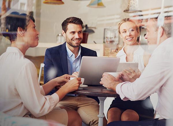 Smiling businesspeople discussing the company travel policy in meeting