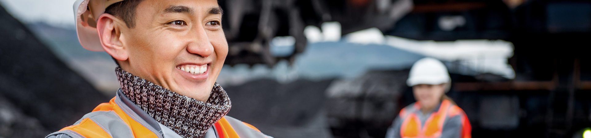 Miner in hi-vis and hard hat on mine site, one of the resource sectors serviced by resource travel management