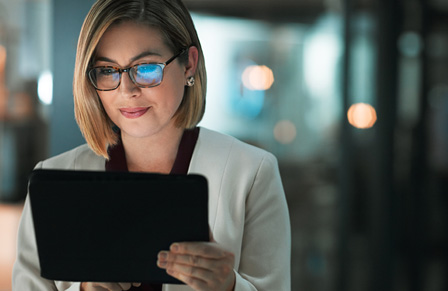 Businesswoman looking at CTM Meetings & Events event technology offerings on tablet